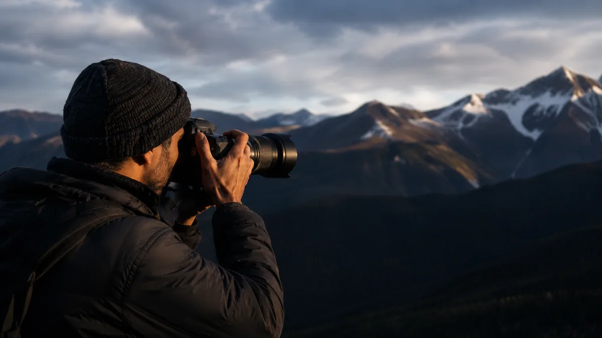 Photographer capturing a mountain landscape